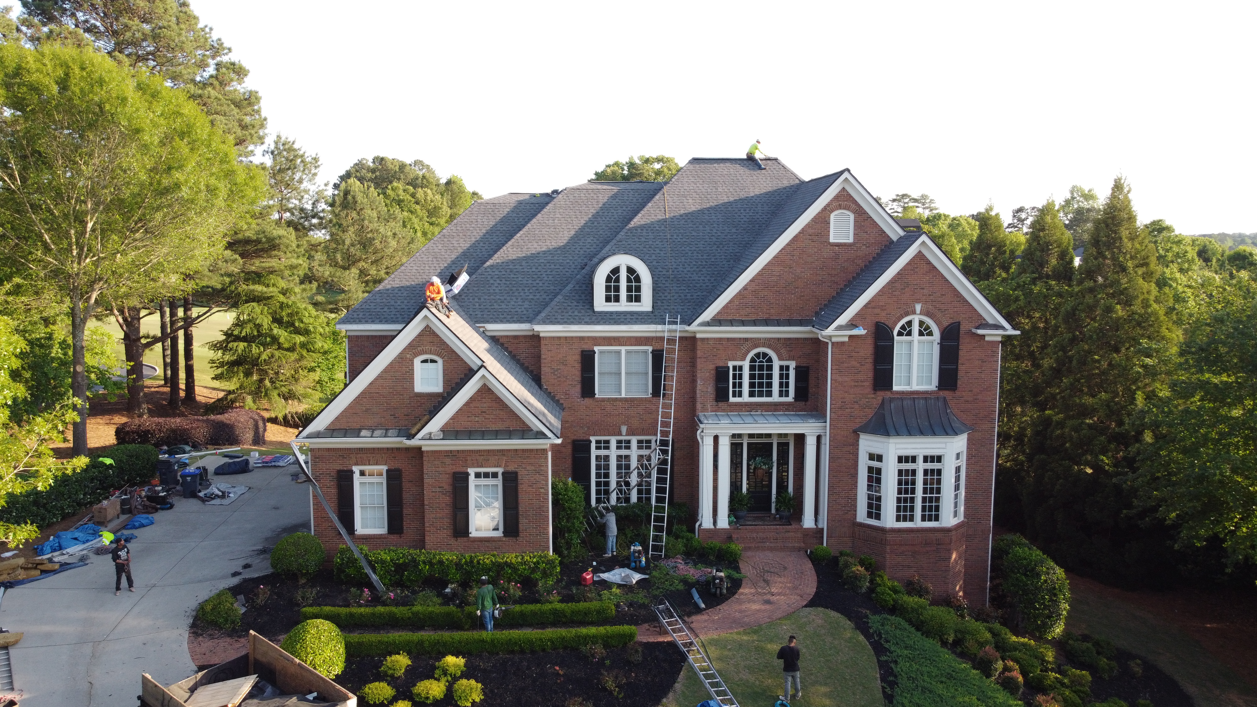 Completed roof installation in Roswell GA by 1 Source Roofing with warranty documentation